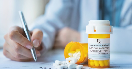 doctor with medication bottle